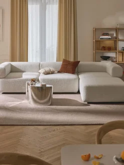 Sofá modular en tejido bouclé Anton (4 plazas), con reposapiés (izquierda/derecha)