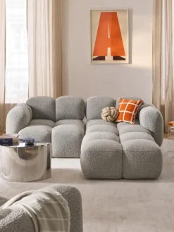 Sofá modular en tejido bouclé con reposapiés Tayla (3 plazas)